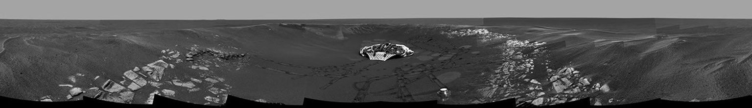 This image from NASA's Mars Exploration Rover Opportunity shows a panoramic view of the crater informally referred to as 'Eagle Crater,' which is approximately 72 feet in diameter. Opportunity's lander and track marks are visible.
