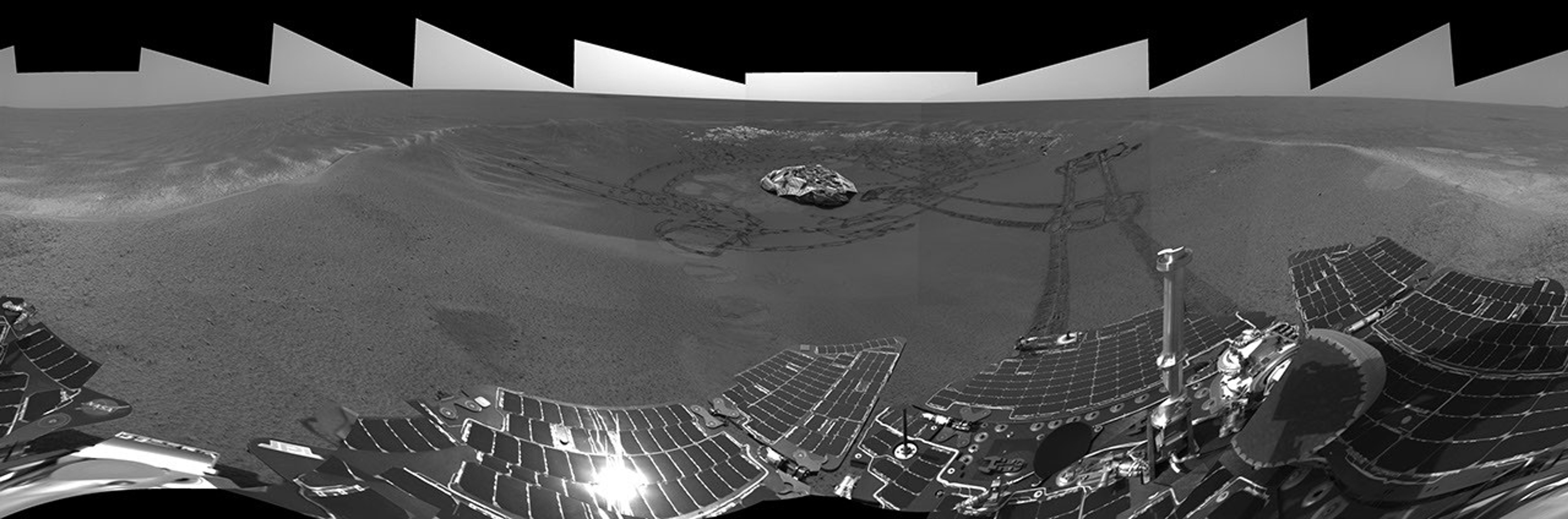 This image from NASA's Mars Exploration Rover Opportunity's view shows the rover's tracks visible at the original spot where the rover attempted unsuccessfully to exit its landing site crater in 2004.