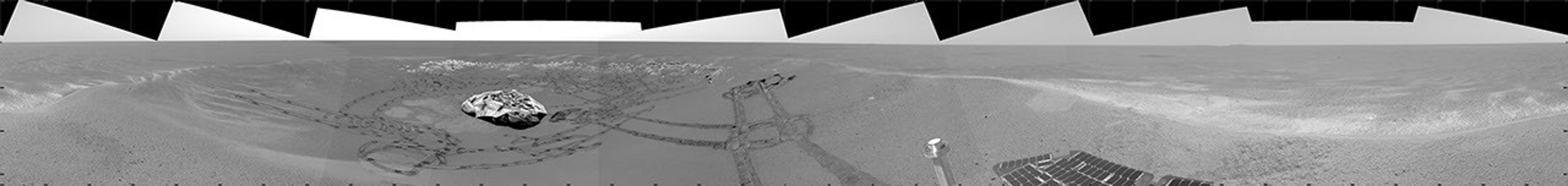 This image from NASA's Mars Exploration Rover Opportunity's view shows the rover's tracks visible at the original spot where the rover attempted unsuccessfully to exit its landing site crater in 2004.
