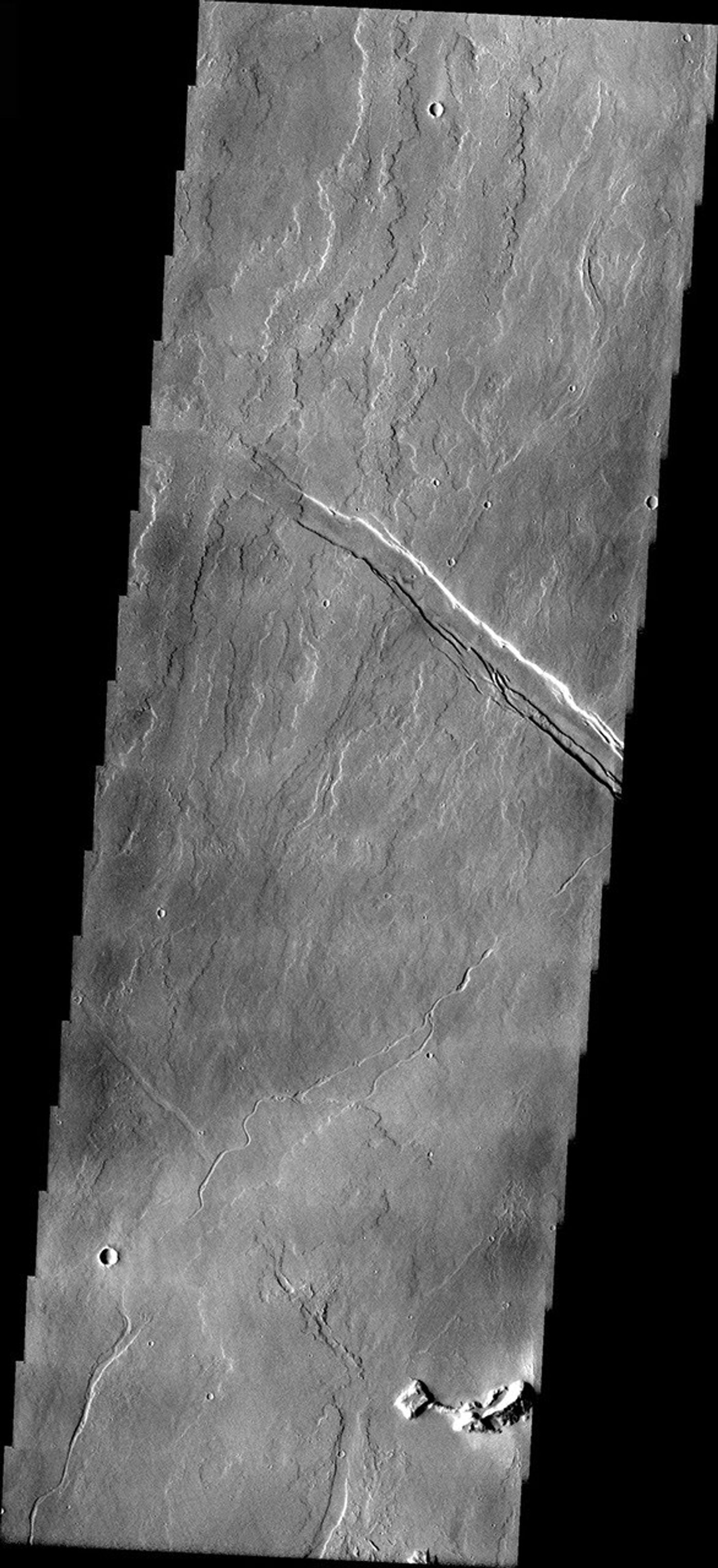 This image from NASA's 2001 Mars Odyssey released on April 5, 2004 shows volcanic flows from Olympus Mons and the formation of the structural feature can be deduced by which flows are cut by the fracture and which flows fill and cross the fracture.