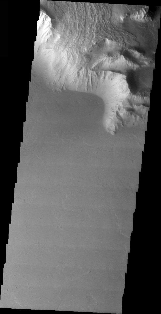 This image from NASA's 2001 Mars Odyssey released on April 6, 2004 shows late stage volcanic flows coming down the side of Olympus Mons and flowing over the cliff-like margin of the volcano.