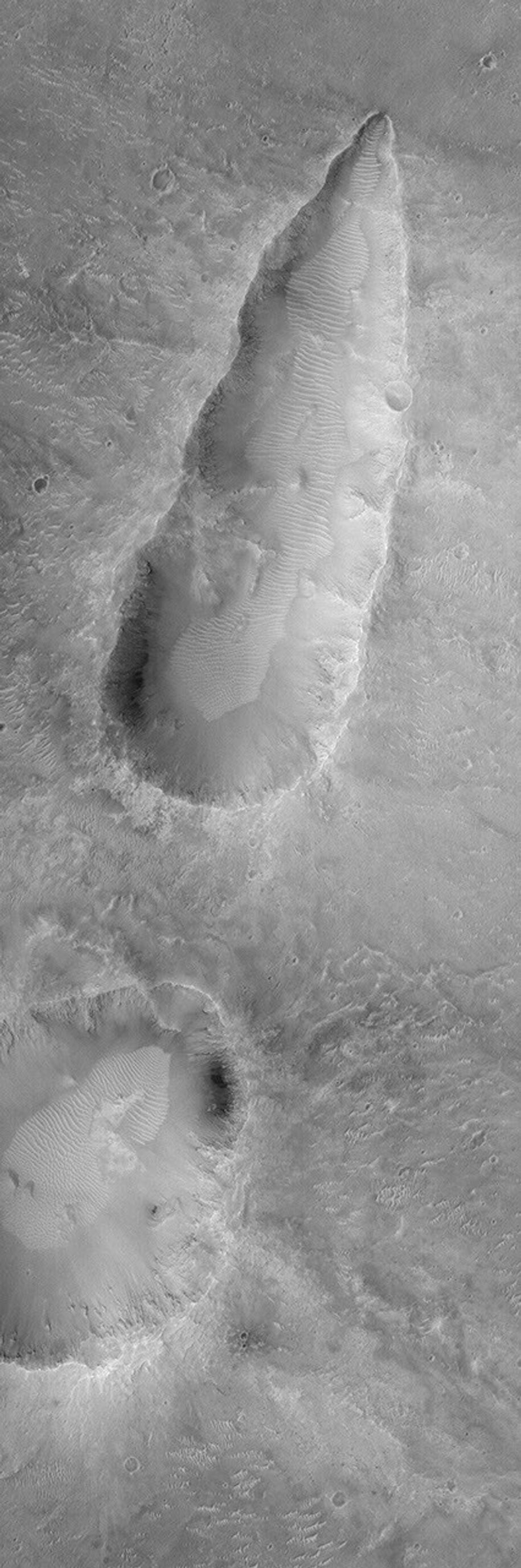 NASA's Mars Global Surveyor shows the results of an oblique meteor impact on Mars.