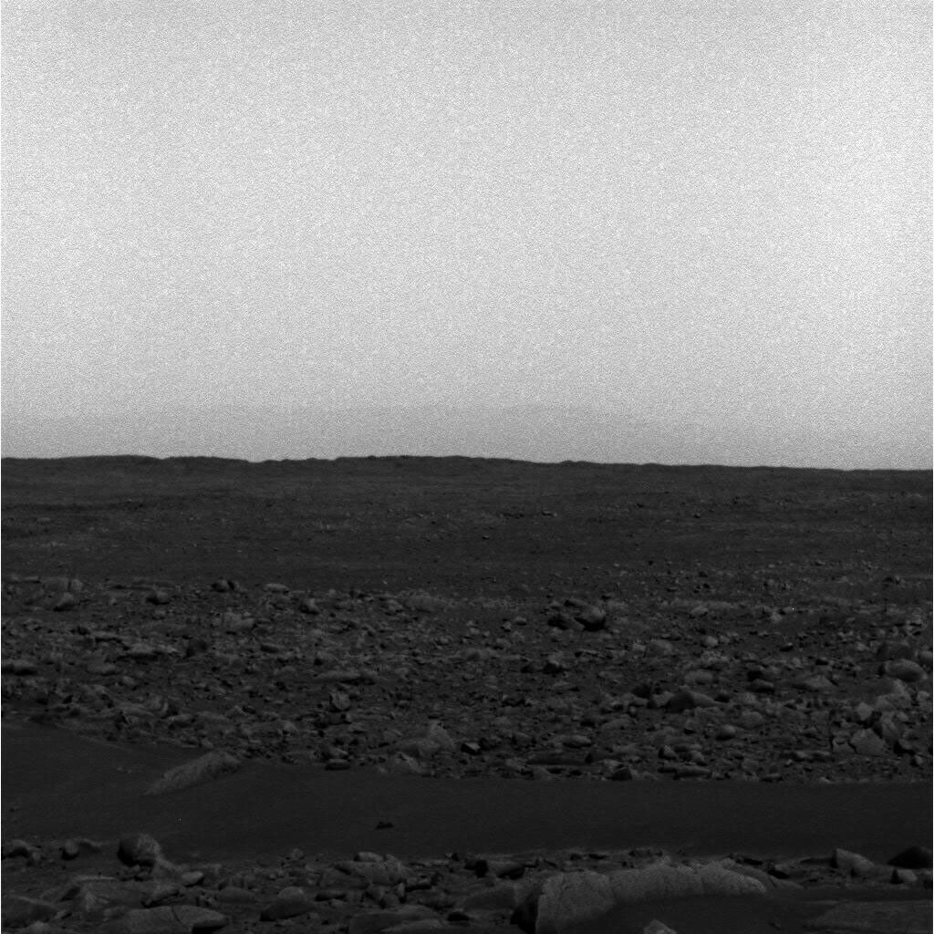 NASA's Mars Exploration Rover Spirit took this panoramic camera image of the southeast rim of Gusev Crater capturing the crater wall as it descends into the mouth of the Ma'adim Vallis channel. The martian skies were dusty obscuring the crater rim.