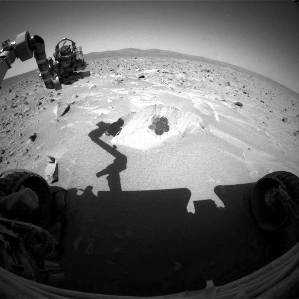 This image taken by the hazard-avoidance camera onboard NASA's Mars Exploration Rover Spirit on sol 99 shows the rock dubbed 'Route 66' and a flower-shaped brush mark made by the rover's rock abrasion tool.