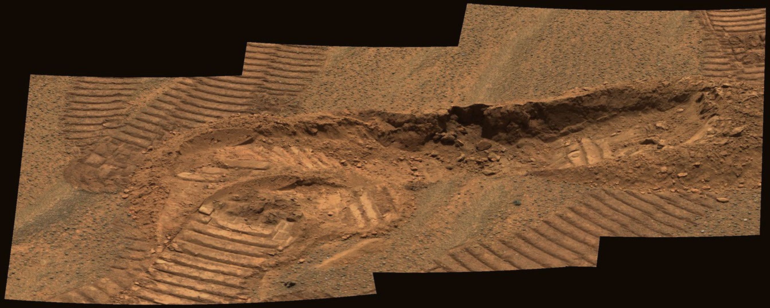 This image from the panoramic camera on NASA's Mars Exploration Rover Opportunity shows a trench dug by the rover in the vicinity of the 'Anatolia' region. Two imprints from the rover's Moessbauer spectrometer instrument were left in the exposed soils.