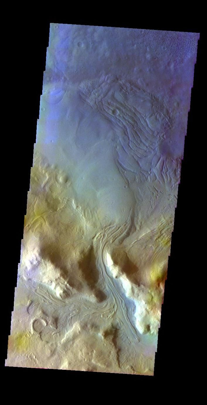 This false-color image released on May 27, 2004 from NASA's 2001 Mars Odyssey of material entering Moreux Crater from the rim area on Mars was acquired March 17, 2003, during northern summer.