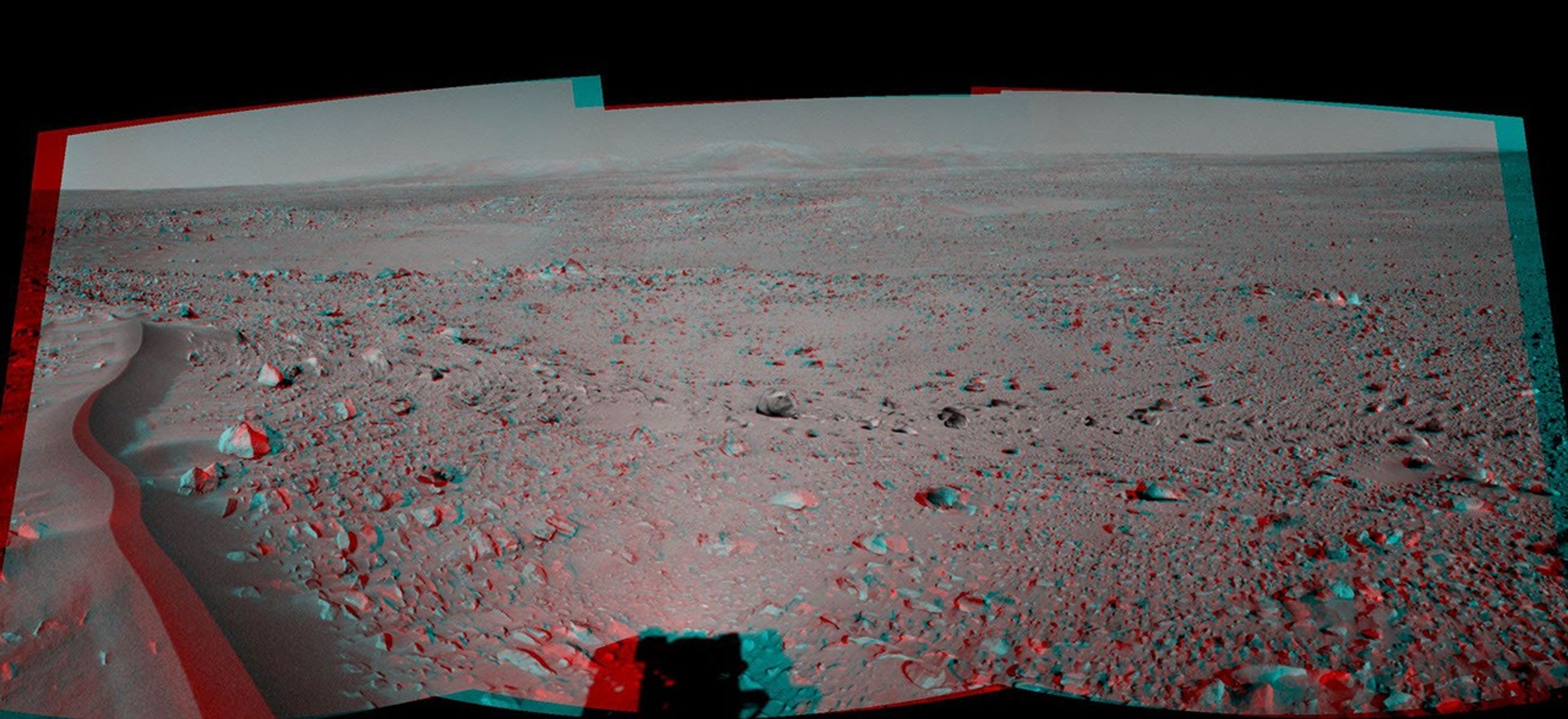 This 120-degree three dimensional anaglyph view from NASA's Mars Exploration Rover Spirit highlights a crater approximately 70 meters (230 feet) in diameter informally named 'Lahontan.' 3D glasses are necessary to view this image.