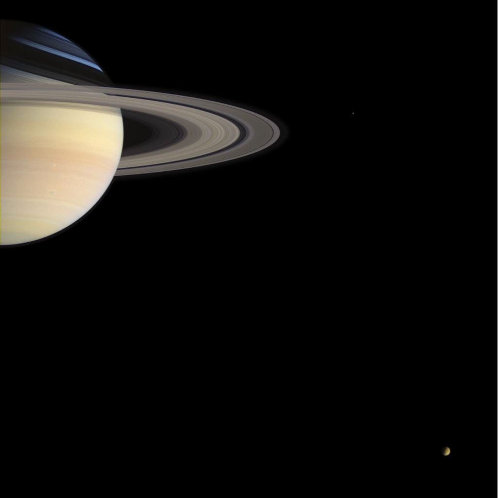 From its station nearly 1.2 billion kilometers (746 million miles) from Earth, NASA's Cassini spacecraft sends holiday greetings to Earth with this lovely color portrait of Saturn and two of its moons.