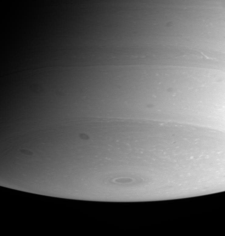 This view of Saturn's southern polar region is dotted with flecks of bright cloud and several ominous dark spots. Remarkably fine details are visible. This image was taken with NASA's Cassini spacecraft's narrow angle camera on July 24, 2004.