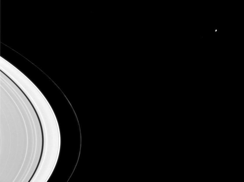 Mimas, seen here beyond Saturn's rings, is a major sculptor of Saturn's rings. The image was taken in visible light by NASA's Cassini spacecraft's narrow angle camera on Sept. 7, 2004.