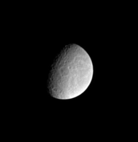 Features on the surface of Saturn's moon Rhea reveal clues about the moon's history. This image from NASA's Cassini spacecraft shows two large impact basins near center and bottom exhibit central peaks.
