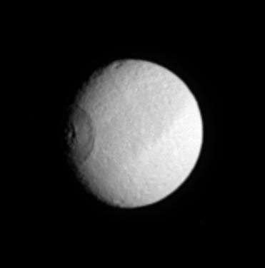 Saturn's moon Tethys turns like a great eye as the enormous crater Odysseus (450 kilometers or 280 miles across) rotates into NASA's Cassini spacecraft's view.