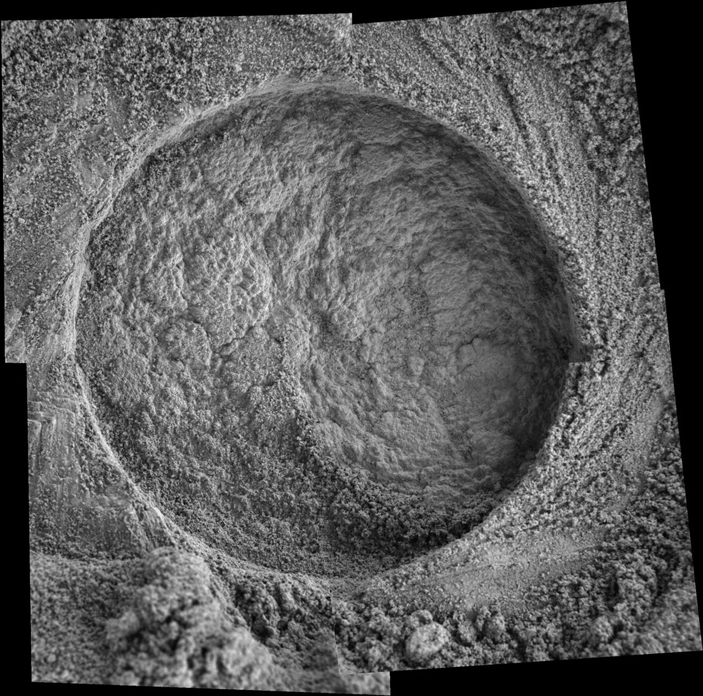 This microscopic imager mosaic of the target area called 'Diamond Jenness' was taken after NASA's Mars Exploration Rover Opportunity ground into the surface with its rock abrasion tool for a second time.