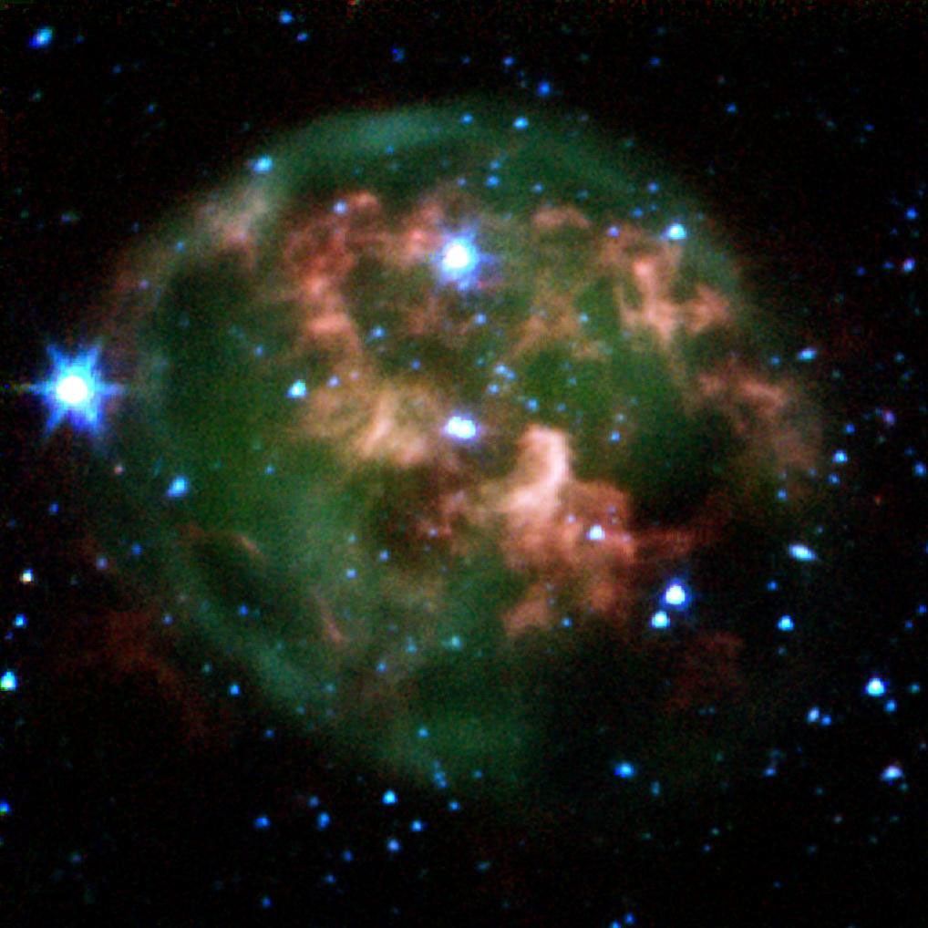 This false-color image from NASA's Spitzer Space Telescope shows a dying star (center) surrounded by a cloud of glowing gas and dust.