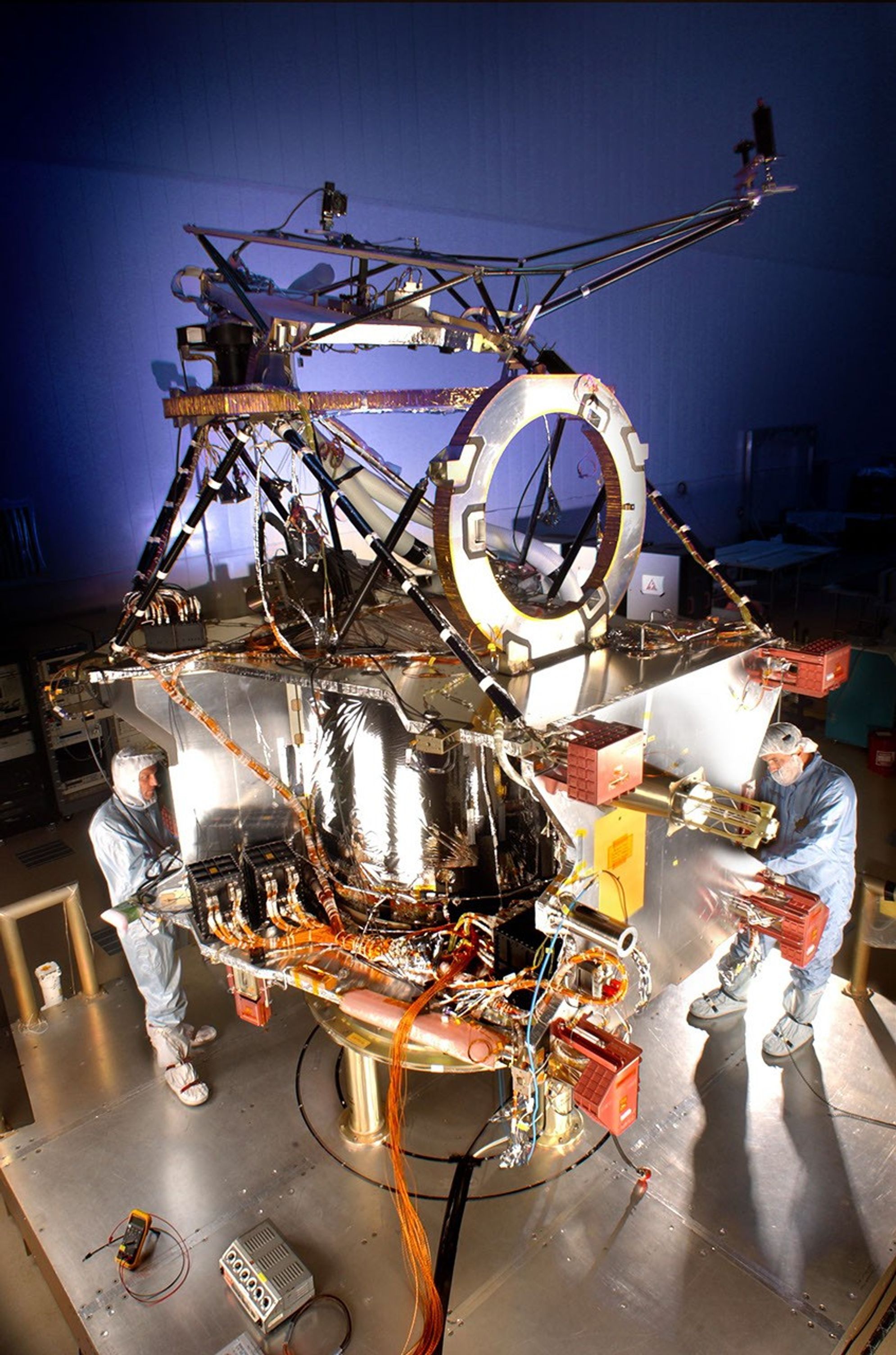 Lockheed Martin Space Systems engineer Terry Kampmann (left) and lead technician Jack Farmerie work on assembly and test of NASA's Mars Reconnaissance Orbiter spacecraft bus in a cleanroom at the company's Denver facility.