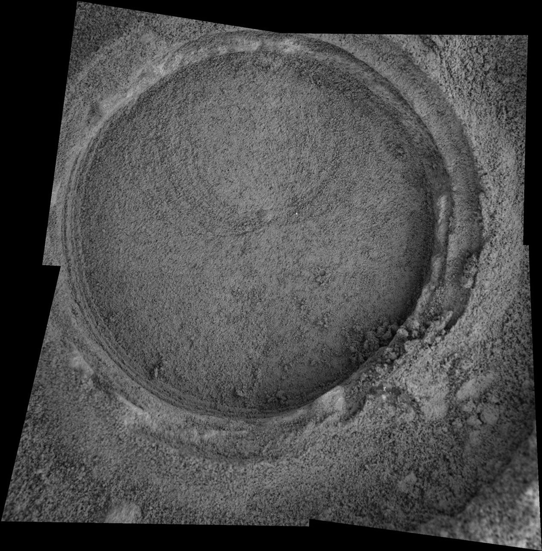 This image taken by NASA's Mars Exploration Rover Opportunity shows a target dubbed 'Bylot' on the slopes of 'Endurance Crater.' Opportunity dug a hole into the target with its rock abrasion tool.