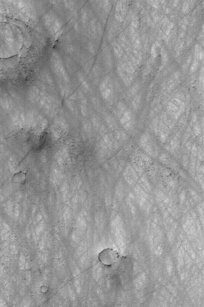 NASA's Mars Global Surveyor shows hundreds of dust devils may streak across the landscape, creating criss-cross patterns on the surface of Mars.