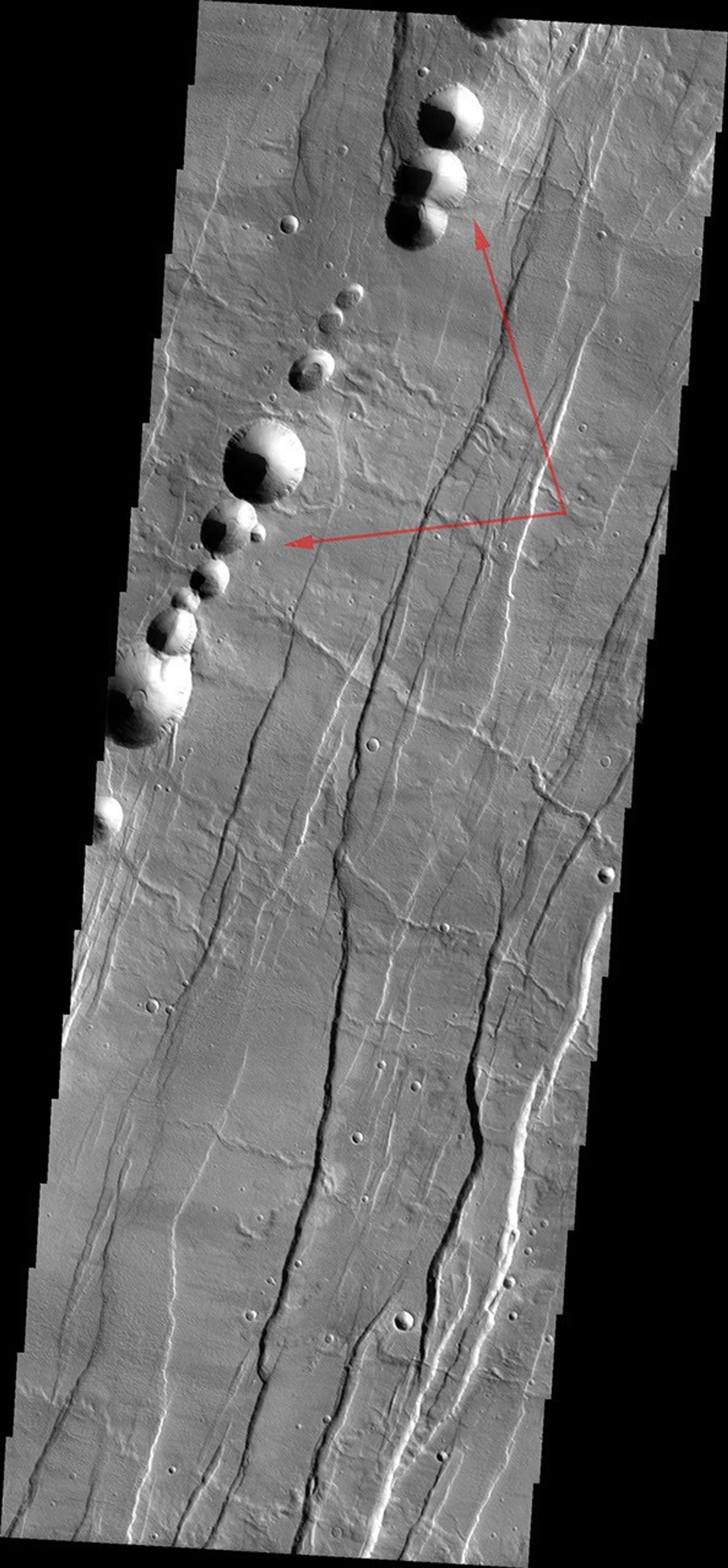 This image released on August 24, 2004 from NASA's 2001 Mars Odyssey shows Acheron Catera, a line of craters found on the flanks of Alba Patera -- a very old volcano on Mars.