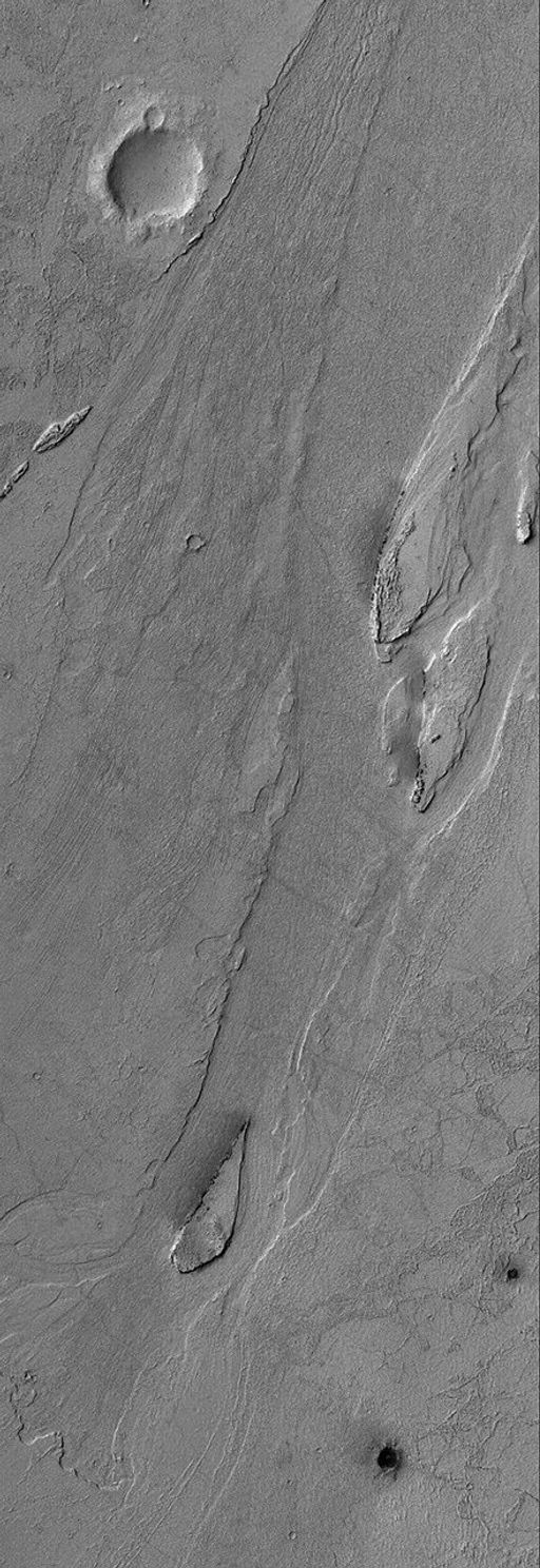 NASA's Mars Global Surveyor shows streamlined islands and a small cataract in an outflow channel system in the Zephyria region of Mars, south of Cerberus.