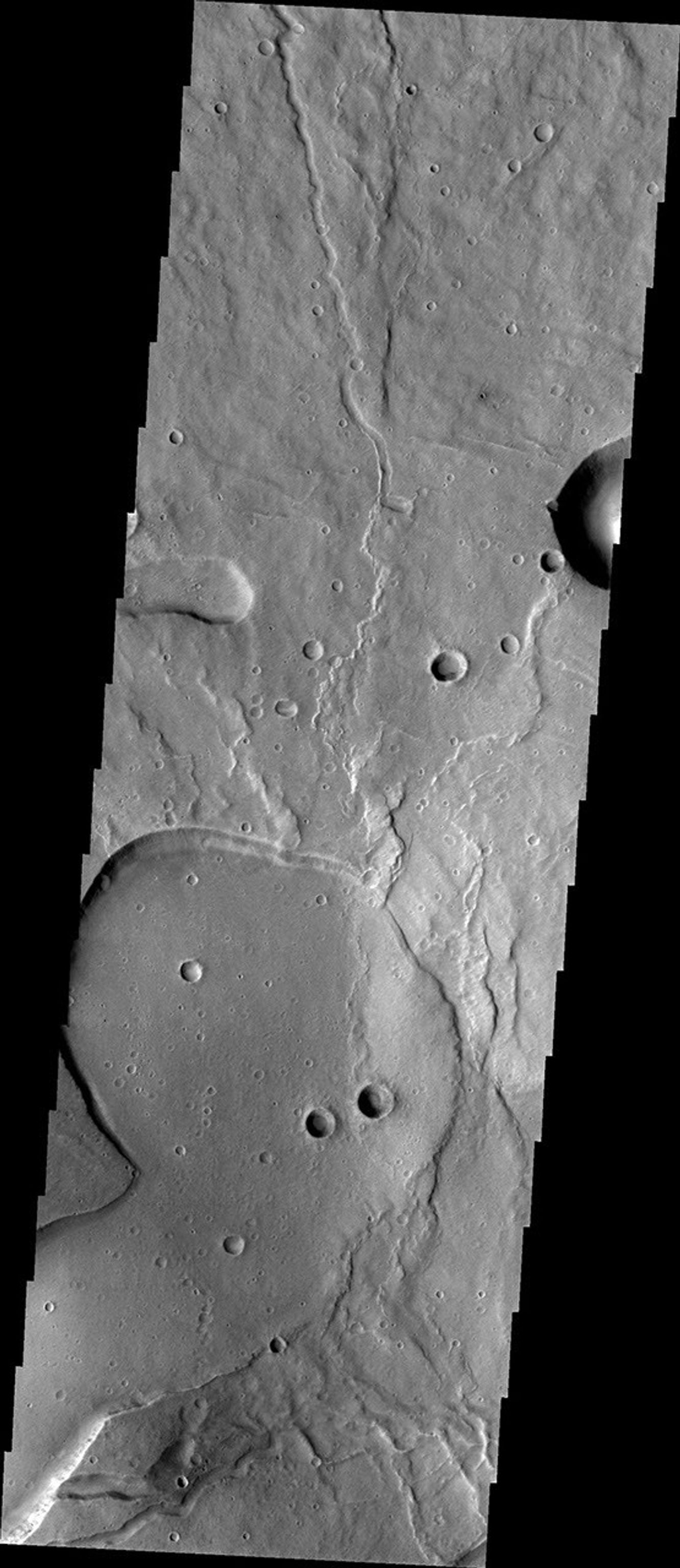 This image released on Oct 11, 2004 from NASA's 2001 Mars Odyssey shows Tyrrhena Patera and its surroundings. Tyrrhena Patera is one of several moderate sized volcanoes located in the Martian southern highlands.