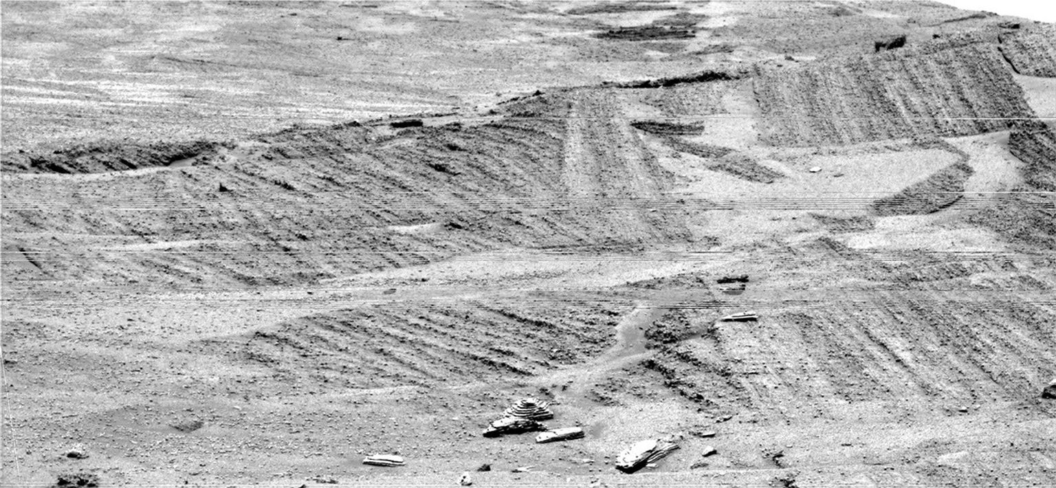 NASA's Mars Exploration Rover Opportunity tried to get as detailed a look as possible at a target region near eastern foot of 'Burns Cliff.' The intervening layered terrain was too difficult for driving the rover closer.