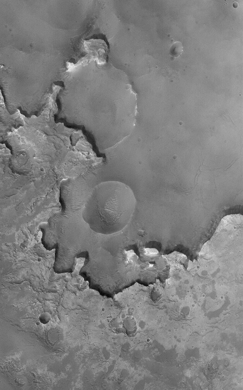 NASA's Mars Global Surveyor shows an example of light-toned sedimentary rocks outcropping in a crater in western Arabia on Mars.