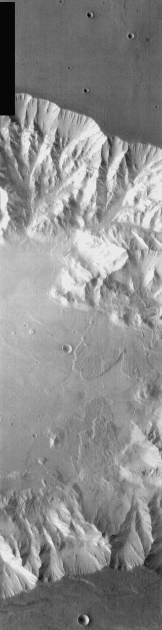This image from NASA's Mars Odyssey shows a portion of Coprates Chasma on Mars, part of Valles Marineris with multiple large landslides.