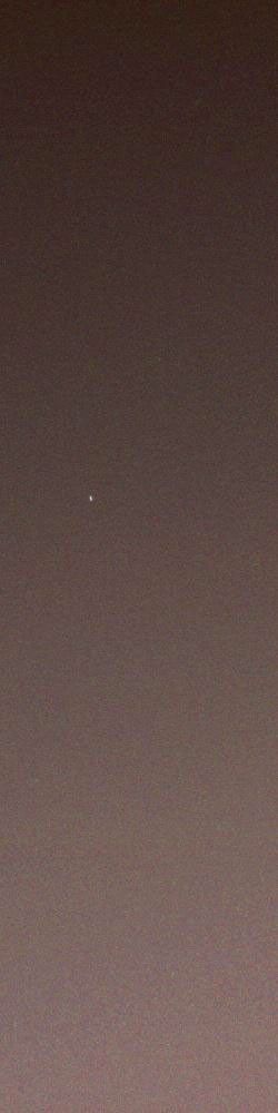 On April 29, 2005, NASA's Mars rover Opportunity woke up approximately an hour after sunset and took this picture of the fading twilight as the stars began to come out. Set against the fading red glow of the sky, is the pale dot of Earth.