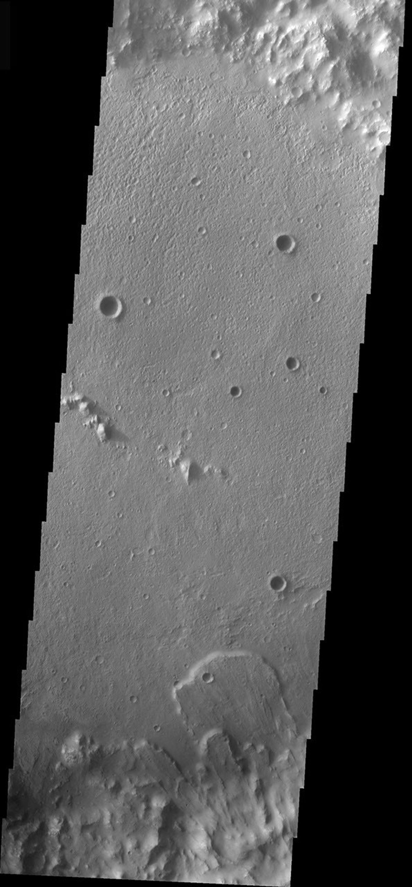 This image from NASA's Mars Odyssey shows a landslide located inside an impact crater located south of the Isidis Planitia region of Mars, formed due to slope failure of the inner crater rim.