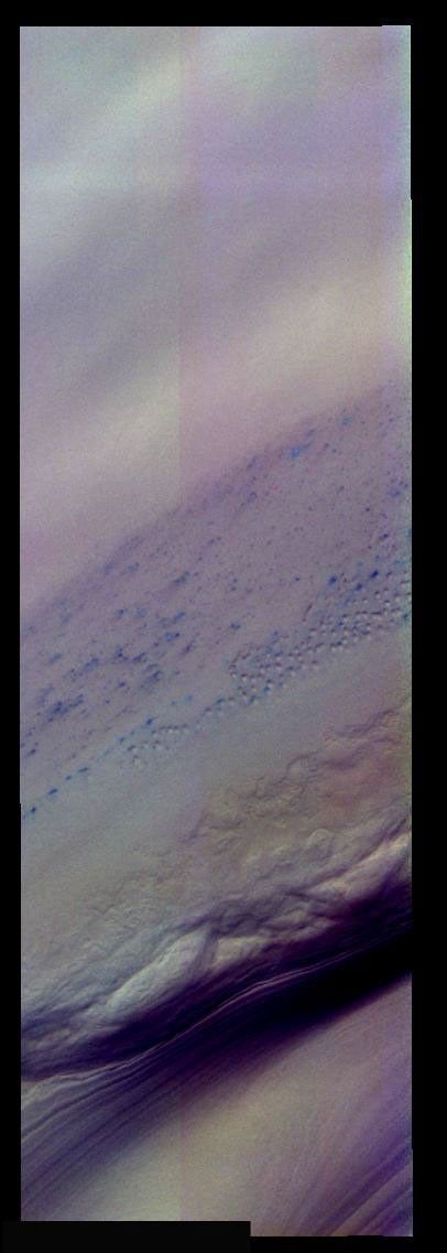Small dunes on Mars in this false-color image from NASA's Mars Odyssey are 'bluer' than the rest of the layered ice/dust units to the left. Ice/frost will appear as bright blue in color; dust mantled ice will appear in tones of red/orange.