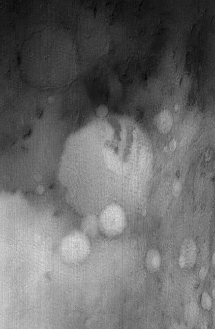 NASA's Mars Global Surveyor shows the crater, Terby, and its vicinity in December 2004. Located north of Hellas, this region on Mars can be covered with seasonal frost and ground-hugging fog, even in the afternoon.