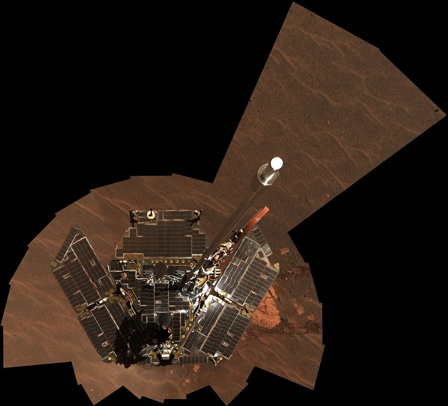 This image taken on Dec. 19 and 20, 2004 by NASA's Mars Exploration Rover Opportunity shows the downward-looking view omits the mast on which the camera is mounted. It shows Opportunity's solar panels to be relatively dust-free.