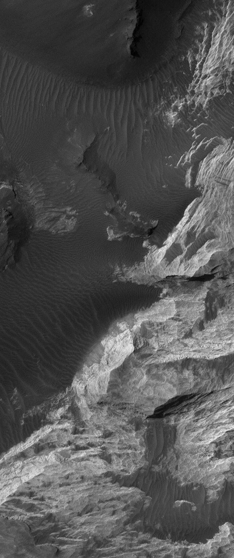 NASA's Mars Global Surveyor shows light-toned sedimentary rocks exposed by erosion in the Iani Chaos region of Mars.