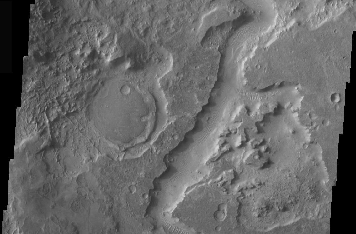 This image is part of THEMIS art month, taken by NASA's Mars Odyssey featuring a portion of Mars' landscape looking somewhat like Pac-Man.