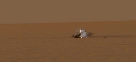 NASA's Mars Exploration Rover Opportunity reveals the scene of the rover's heat shield impact that protected it while hurtling through the martian atmosphere. This image was taken on Dec. 19, 2004.