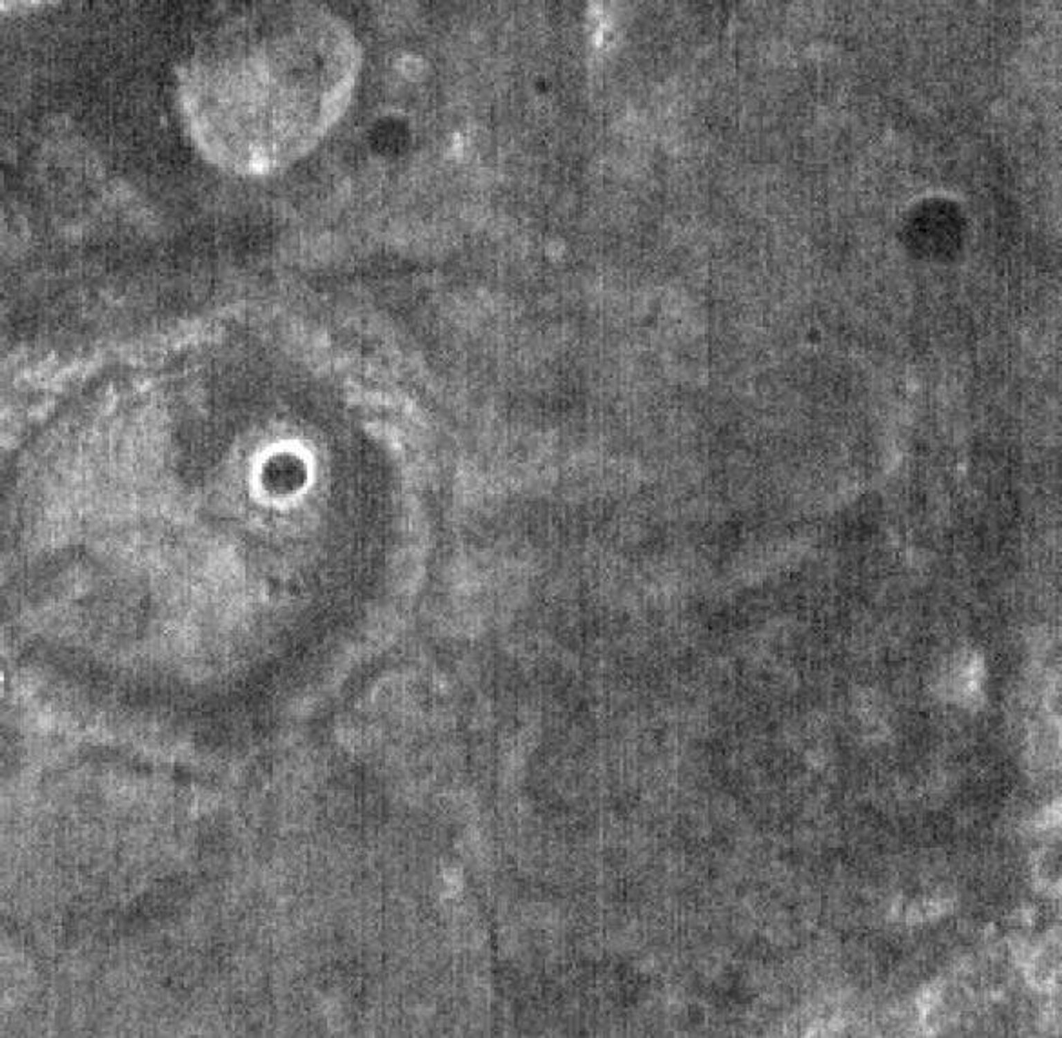 This image, part of THEMIS art month, taken by NASA's Mars Odyssey features a portion of Mars' landscape looking like a face staring at the spacecraft.