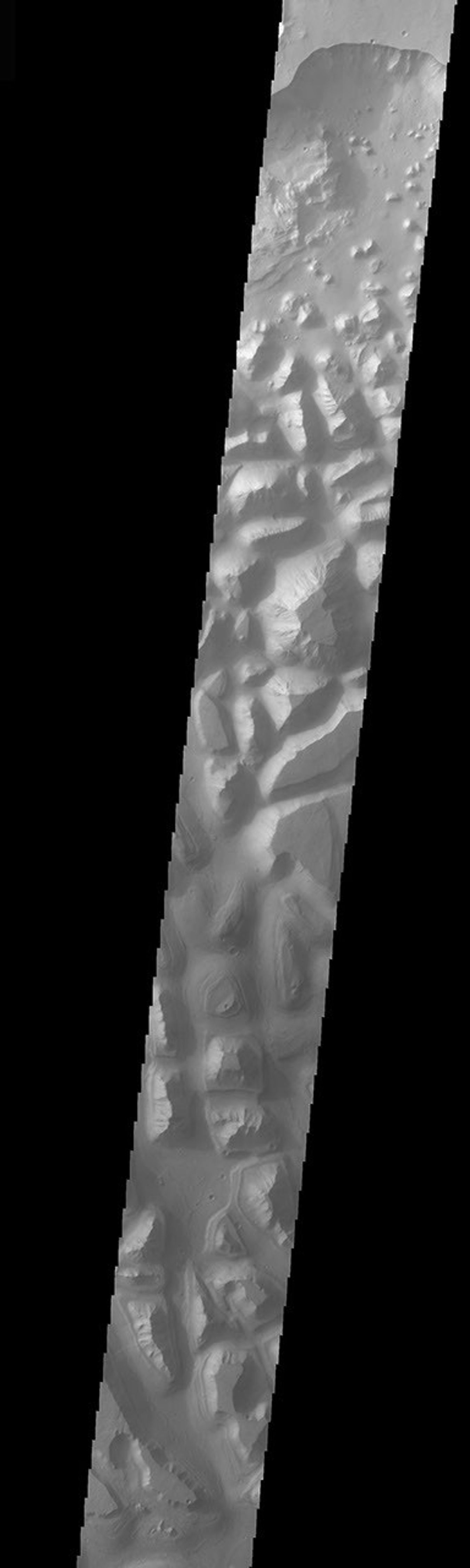 This image taken by NASA's Mars Odyssey shows Hydraotes Chaos, the large chaos terrain just east of Valles Marineris on Mars. Chaos is the blocky landscape after the transport and removal of subsurface support.