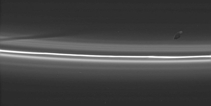 Prometheus poses here with its latest creation: a dark, diagonal gore in the tenuous material interior to Saturn's F ring. This image was taken in visible light with NASA's Cassini spacecraft's narrow-angle camera on Aug. 20, 2005.