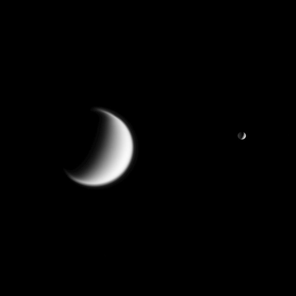 Titan, Saturn's largest moon and Mimas in the foreground are seen together in this view from NASA's Cassini spacecraft. Titan's gravity is weaker than Earth's, so the moon's atmosphere is quite extended -- a quality hinted at in this view.