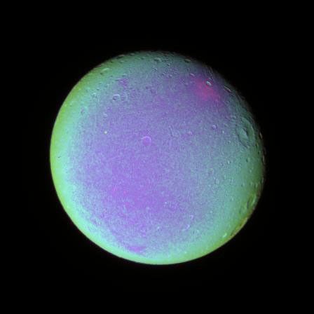 The leading hemisphere of Dione displays subtle variations in color across its surface in this false color view from NASA's Cassini spacecraft takene on Dec. 24, 2005.