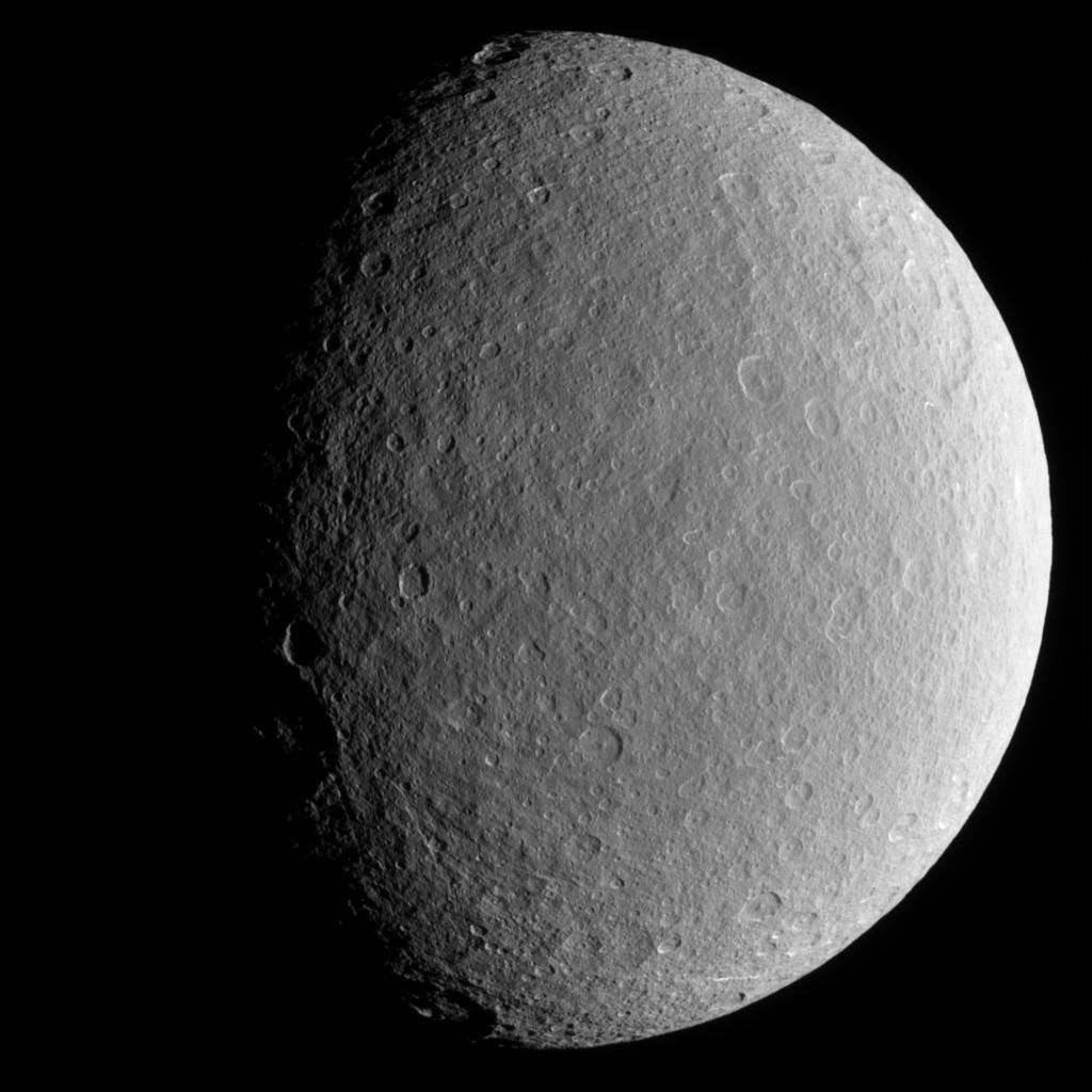 Scarred and battered Rhea fills NASA's Cassini spacecraft's view. Notable here is the sharp relief of steep crater walls near the terminator. Icy Rhea (1,528 kilometers, or 949 miles across) is Saturn's second-largest moon.