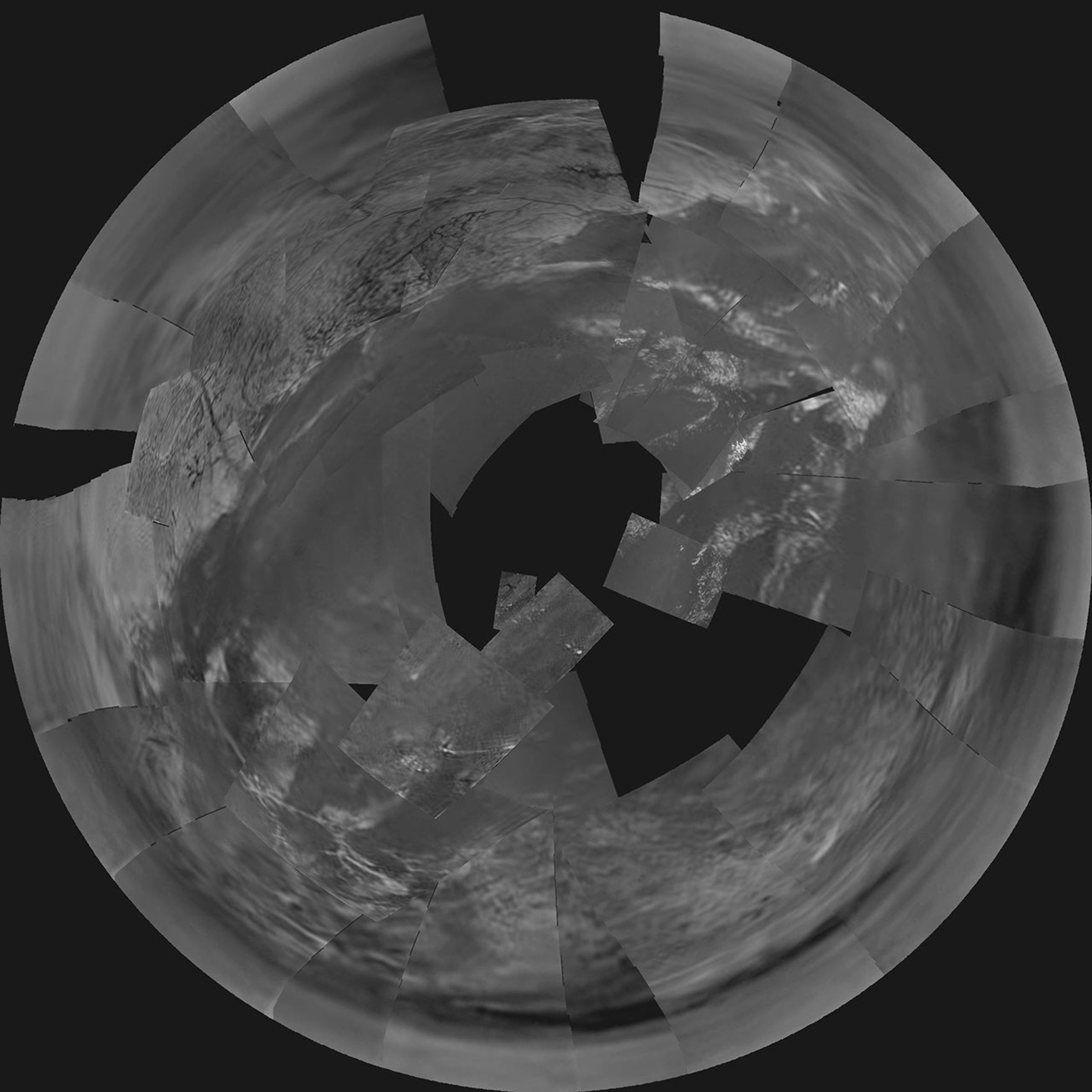 This stereographic projection of NASA's Descent Imager/Spectral Radiometer images from the European Space Agency's Huygens probe combines 60 images in 31 triplets, projected from a height of 3,000 meters above the black 'lakebed' surface.