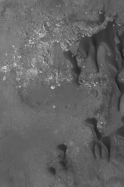NASA's Mars Global Surveyor shows dark-toned sand dunes on the floor of Stokes Crater, located on the martian northern plains.