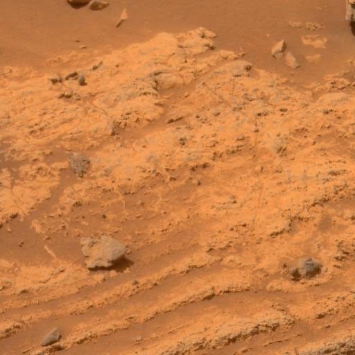 This view of layers around the edge of a low plateau called 'Home Plate' inside Mars' Gusev Crater includes a feature that may be what geologists call a 'bomb sag' and interpret as evidence of an explosive event, such as a volcanic eruption