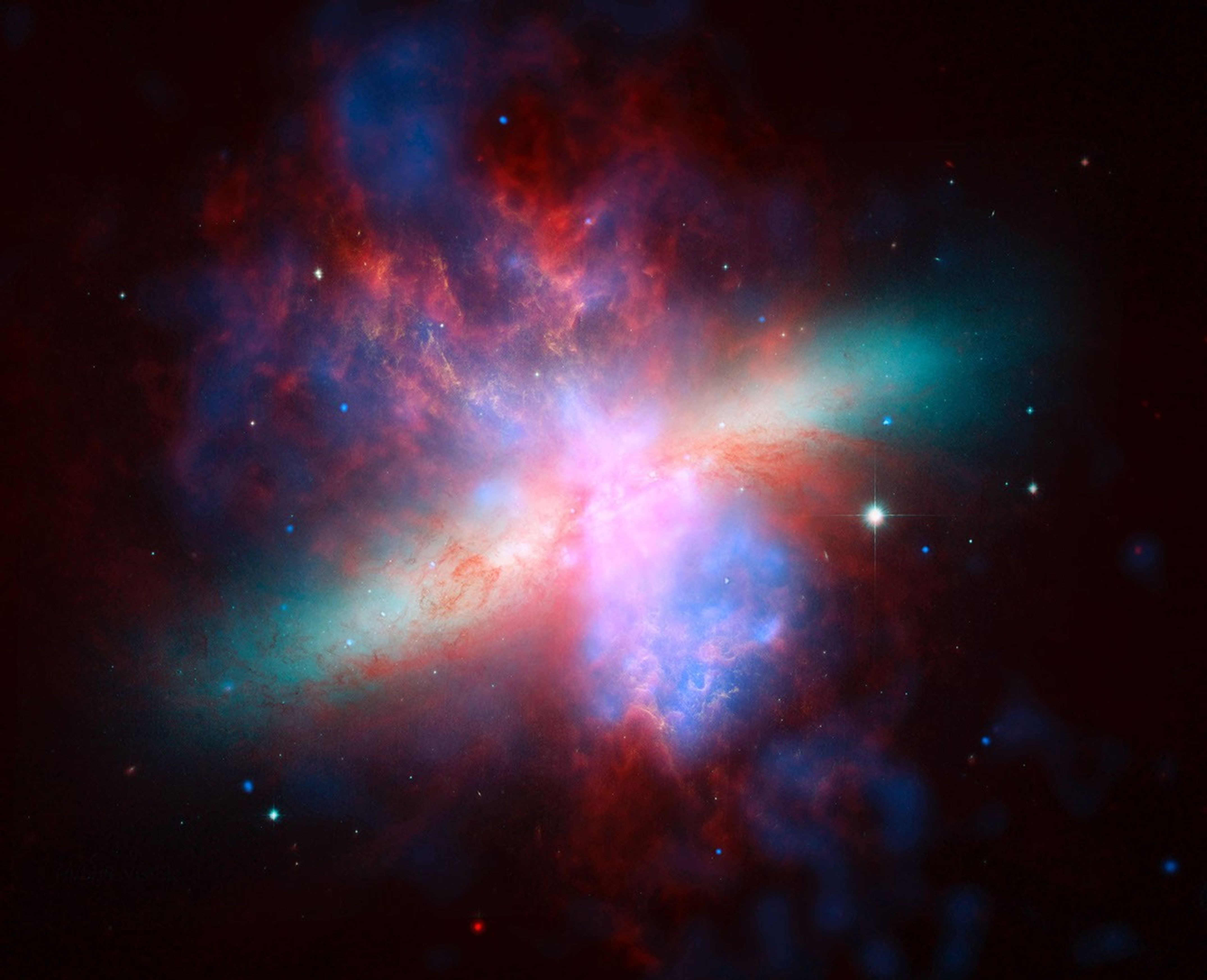 NASA's Spitzer, Hubble and Chandra space observatories teamed up to create this multi-wavelength, false-colored view of the M82 galaxy. The lively portrait celebrates Hubble's 'sweet sixteen' birthday.