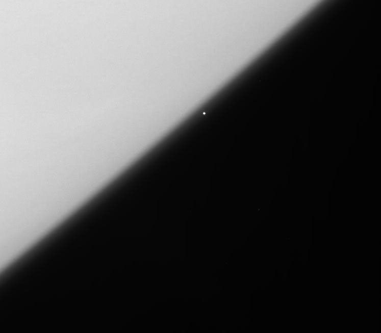 The brilliant supergiant star, Rigel, emerges from behind the haze of Saturn's upper atmosphere in this view captured by NASA's Cassini spacecraft.