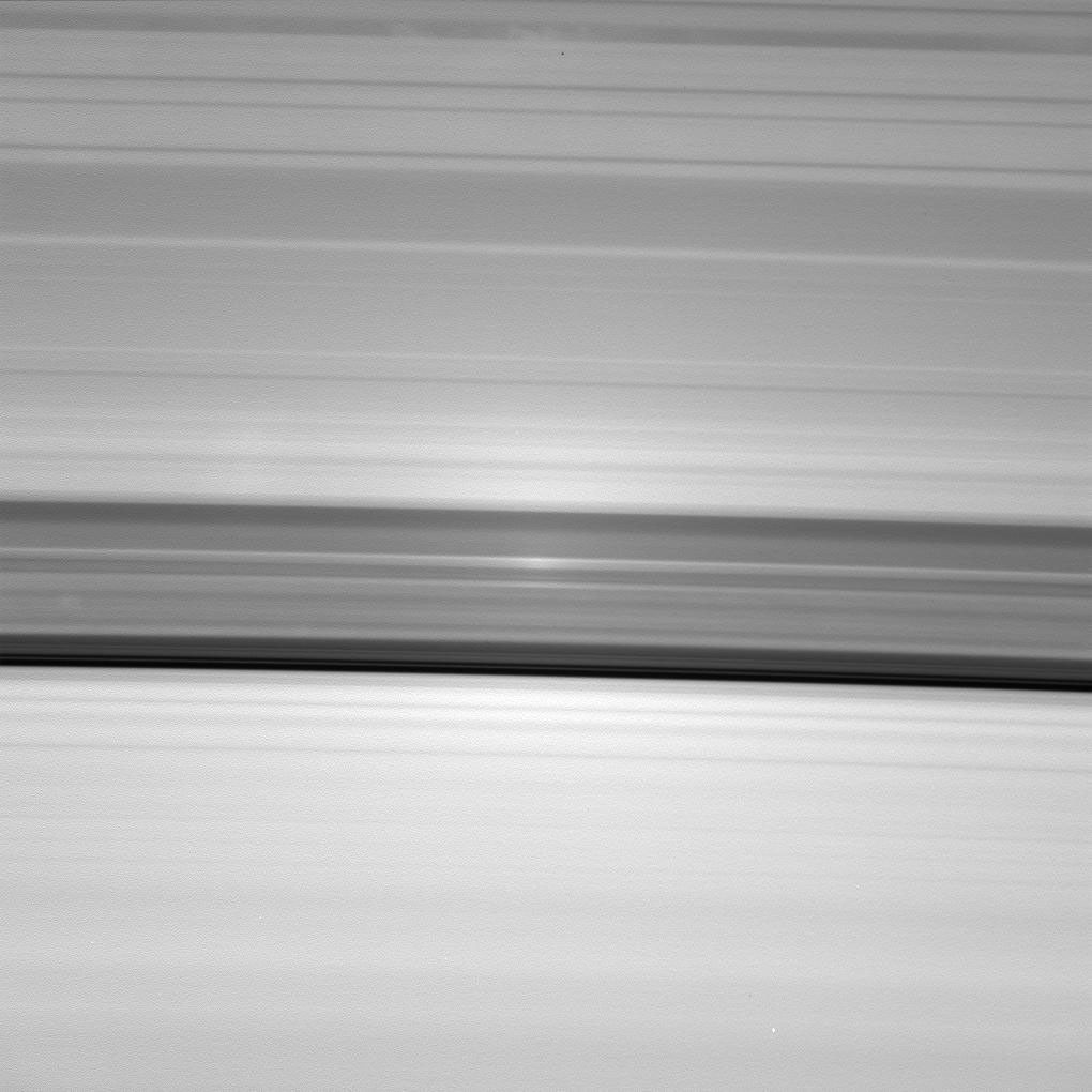 A brilliant spot of sunlight, the opposition effect, travels outward across the rings as NASA's Cassini spacecraft orbits Saturn. This surge in ring brightness is created around the point directly opposite the Sun from the spacecraft.