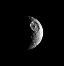 The great basin that interrupts the contours of this moon's crescent identifies the satellite unmistakably as Mimas. The giant crater Herschel is this moon's most obvious feature as seen by NASA's Cassini spacecraft.