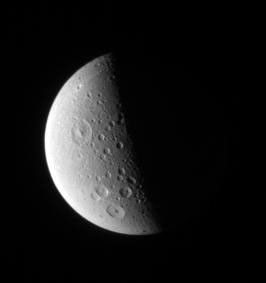 Craters of all sizes litter the landscape on Saturn's Dione. The larger craters in this view display prominent central peak in this image captured by NASA's Cassini spacecraft on Oct. 12, 2006.