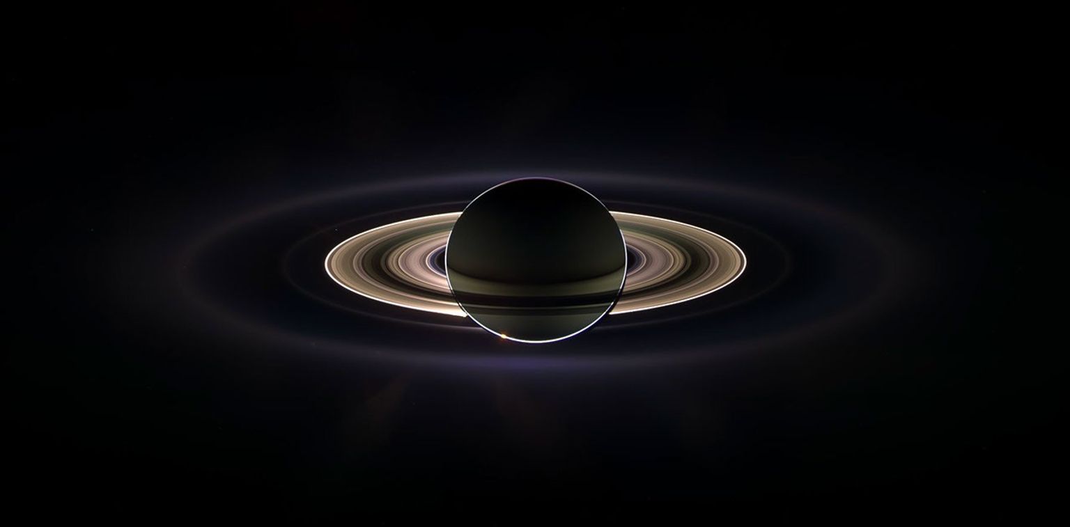 With giant Saturn hanging in the blackness and sheltering NASA's Cassini from the sun's blinding glare, the spacecraft viewed the rings as never before, revealing previously unknown faint rings and even glimpsing its home world.